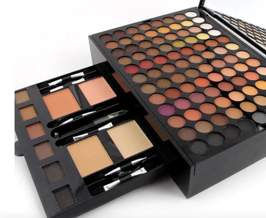Redesign Ultimate Makeup Set with brushes, palettes, and applicators arranged on a neutral background.